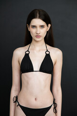 Young beautiful fashion model woman posing in studio, natural beauty, clean skin, professional modeling portfolio, elegant female portrait, modern style, confident look, people concept photography