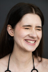 Young brunette woman studio portrait with natural beauty and emotional expressions, close up face, healthy skin, minimal fashion style, modern people and lifestyle concept