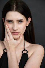 Natural emotional portrait of young woman model with expressive face, authentic beauty, lifestyle mood, clean skin, real emotions, modern female portrait photography in studio