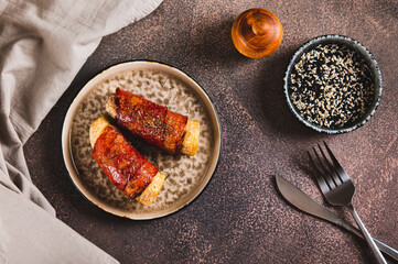 Baked banana roll with bacon on a plate on the table top view