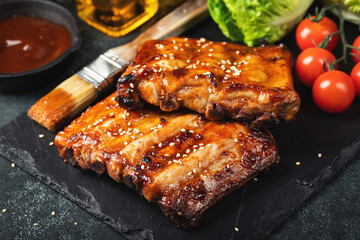 Barbecue pork spare ribs with hot honey chili marinade on black background