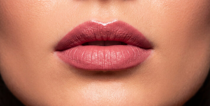Extreme close-up of woman&rsquo;s lips with flawless makeup, studio lighting