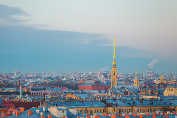 Fototapeta premium View of the spire of the Peter and Paul Cathedral from the Duma Tower. Beautiful sunset.