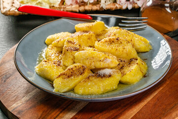 Homemade lazy noodles with cheese, crumbs and melted butter.