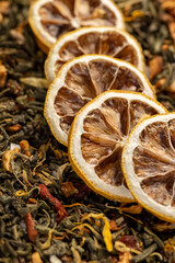 bright large dry lemon slices and green tea with pieces of fruit, high-quality tea with added flavors and pieces of fruit