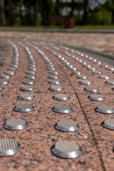 metal elevations on the pavement tiles to ensure safety during rain and frost, anti-slip inserts on the tiles to ensure pedestrian safety in bad weather