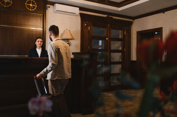 Guest checking in at hotel reception desk