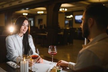 Young woman enjoying romantic dinner date with partner