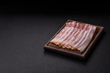 Raw smoked bacon slices, ham, jamon, or prosciutto strips for cooking. Raw bacon slices