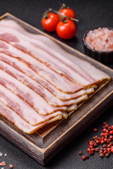 Raw smoked bacon slices, ham, jamon, or prosciutto strips for cooking. Raw bacon slices