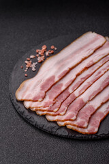 Raw smoked bacon slices, ham, jamon, or prosciutto strips for cooking. Raw bacon slices