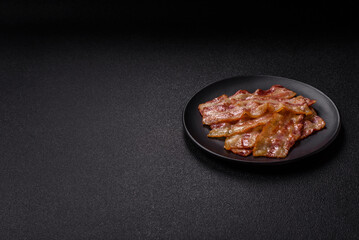 Fried smoked bacon slices, ham, jamon, or prosciutto strips for cooking. Fried bacon