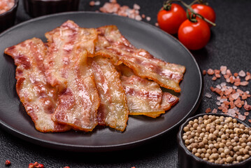 Fried smoked bacon slices, ham, jamon, or prosciutto strips for cooking. Fried bacon