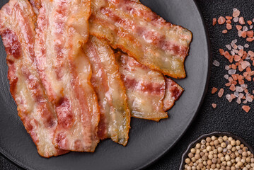 Fried smoked bacon slices, ham, jamon, or prosciutto strips for cooking. Fried bacon