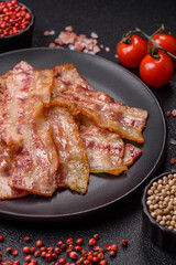 Fried smoked bacon slices, ham, jamon, or prosciutto strips for cooking. Fried bacon