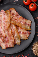 Fried smoked bacon slices, ham, jamon, or prosciutto strips for cooking. Fried bacon