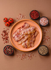 Fried smoked bacon slices, ham, jamon, or prosciutto strips for cooking. Fried bacon