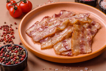 Fried smoked bacon slices, ham, jamon, or prosciutto strips for cooking. Fried bacon