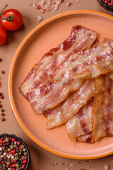 Fried smoked bacon slices, ham, jamon, or prosciutto strips for cooking. Fried bacon