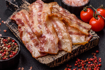 Fried smoked bacon slices, ham, jamon, or prosciutto strips for cooking. Fried bacon