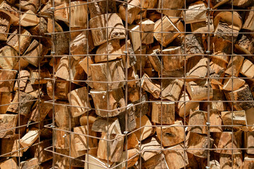 chopped firewood stacked. abstract background with pile of stacked firewood. stacked firewood in natural setting. modern storage for firewood. natural