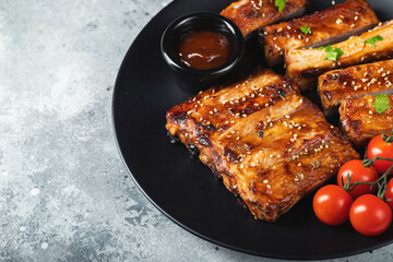 Closeup of pork ribs grilled with BBQ sauce and caramelized in honey.