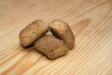 Three golden brown vegetarian instant food snacks are captured in macro detail against a light wooden background. Highlighting the crunchy texture. Ideal for diet promotion.