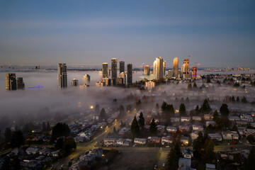 Sunrise Over Foggy Burnaby Skyline With Tall Buildings And Residential Neighborhoods