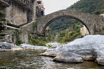 View of Zuccarello, one of the most beautiful villages of Italy with its distinctive Romanesque bridge, Liguria region