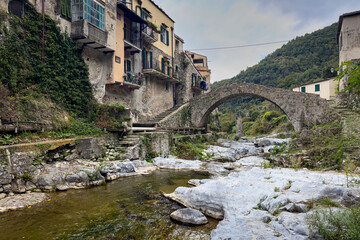 View of Zuccarello, one of the most beautiful villages of Italy with its distinctive Romanesque bridge, Liguria region