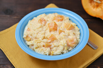 a bowl of pumpkin porridge, homemade food on the table closeup
