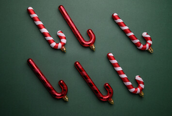 Red and White Striped Candy Canes Holiday Arrangement on Green