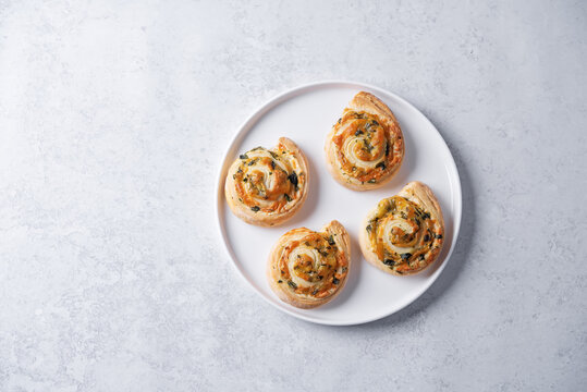 Basil garlic cheese roll cake pinwheel in a plate on a white isolated background