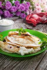 Crepes with ricotta cheese and blackcurrant jam.