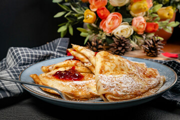 Crepes with cheese and blackcurrant jam.