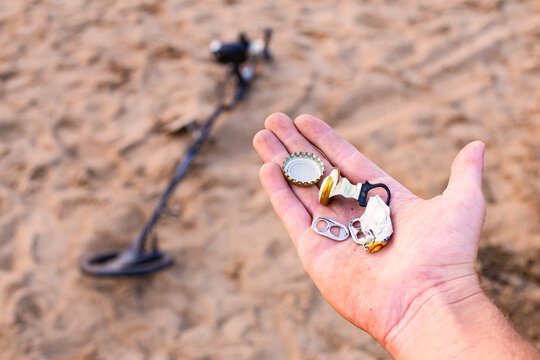beer caps, trash, and other junk found on the beach while searching for jewelry and relics,