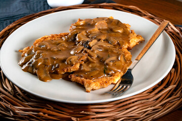 Sauerkraut pancakes /fuczka/ with mushroom sauce .