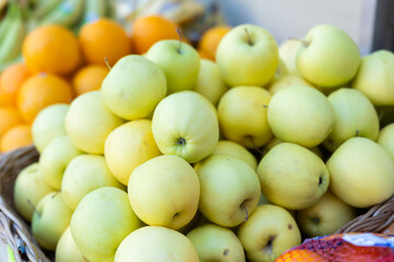 Pyramid of apples is laid out on shop window. Various varieties of green apples are presented in greengrocers shop. .