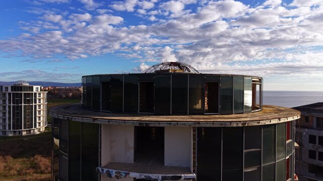 Conus design of the high-rise building with metal rebar cupola on top. Drone footage at the structures at the construction site.