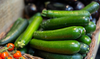 View of zucchini in a wicker basket, put up for sale in a store