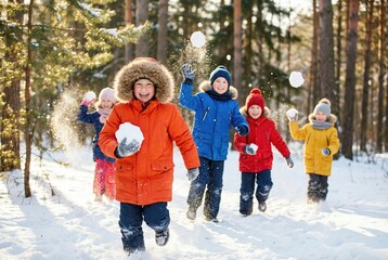 Happy children in colorful winter clothes having a snowball fight in a sunny snowy forest