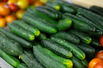View of cucumbers in a wicker basket, put up for sale in a store