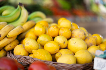 View of lemons in a wicker basket, put up for sale in a store