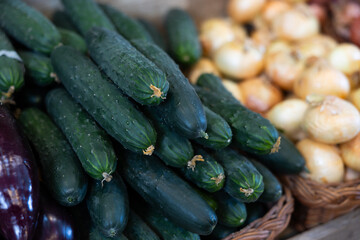 View of cucumbers in a wicker basket, put up for sale in a store