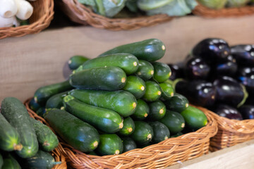 Green zucchini in shop window. Stocks of fruits in stores storage. Fresh fruit vegetable harvest from producer is already on store shelves.
