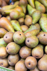 View of ripe pears in a wicker basket, put up for sale in a store