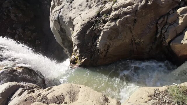 This scenic view captures Mill Creek Falls, the tallest waterfall in the park, cascading 75 feet down a narrow chute, visible from the end of a moderately strenuous trail