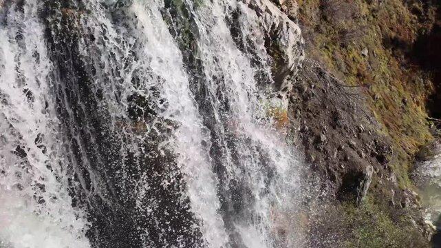 This scenic view captures Mill Creek Falls, the tallest waterfall in the park, cascading 75 feet down a narrow chute, visible from the end of a moderately strenuous trail