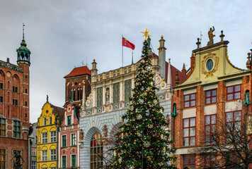 Colourful facades of ancient houses in the Old Town of Gdansk and a Christmas tree
