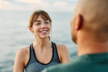 Fototapeta premium Portrait os a happy beautiful couple exercising and stretching outdoors